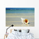 Tropical Seashell On The Beach With Gorgeous Clear Blue Ocean Behind Wall Mural