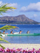 Canoe Paddlers With Orchid Lei In The Foreground Wall Mural