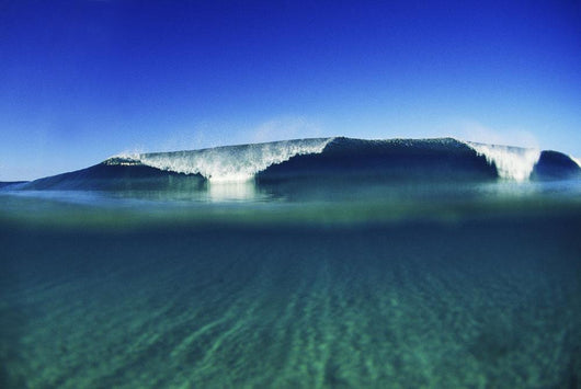 Wave Breaking In Distance, Glassy Turqouise Water In Foreground Wall Mural