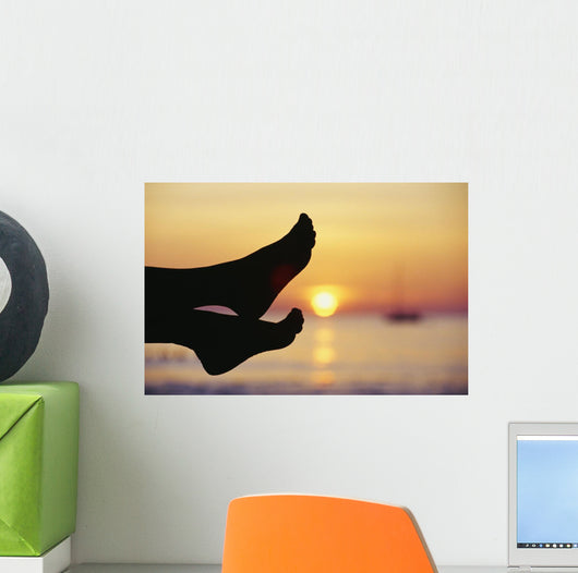 Silhouette Of Feet In Front Of A Sunset Over The Ocean Wall Mural