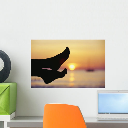 Silhouette Of Feet In Front Of A Sunset Over The Ocean Wall Mural