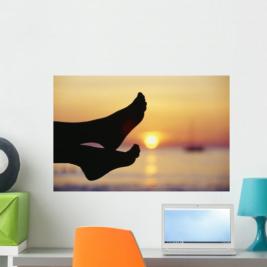 Silhouette Of Feet In Front Of A Sunset Over The Ocean Wall Mural