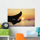 Silhouette Of Feet In Front Of A Sunset Over The Ocean Wall Mural