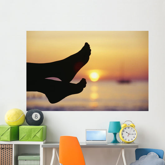 Silhouette Of Feet In Front Of A Sunset Over The Ocean Wall Mural