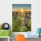 Sunset Over Water And A Fence Along The Shoreline Wall Mural