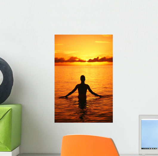 Silhouette Of Woman Wading In The Ocean At Sunrise Wall Mural