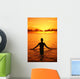 Silhouette Of Woman Wading In The Ocean At Sunrise Wall Mural
