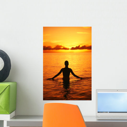 Silhouette Of Woman Wading In The Ocean At Sunrise Wall Mural