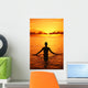 Silhouette Of Woman Wading In The Ocean At Sunrise Wall Mural
