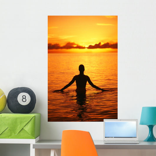 Silhouette Of Woman Wading In The Ocean At Sunrise Wall Mural