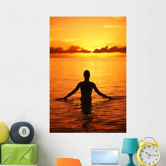 Silhouette Of Woman Wading In The Ocean At Sunrise Wall Mural