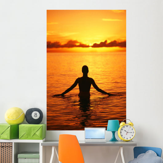 Silhouette Of Woman Wading In The Ocean At Sunrise Wall Mural