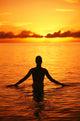 Silhouette Of Woman Wading In The Ocean At Sunrise Wall Mural