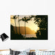Yellow Sunset Through Palm Trees And Vegetation Wall Mural