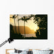 Yellow Sunset Through Palm Trees And Vegetation Wall Mural
