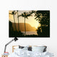 Yellow Sunset Through Palm Trees And Vegetation Wall Mural