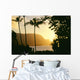 Yellow Sunset Through Palm Trees And Vegetation Wall Mural