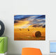 Golden sunset over farm field Wall Mural