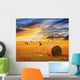 Golden sunset over farm field Wall Mural