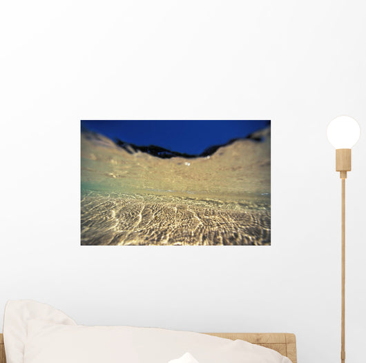 Underwater Reflections Along Sandy Bottom, At Surface Blue Sky Visible Wall Mural