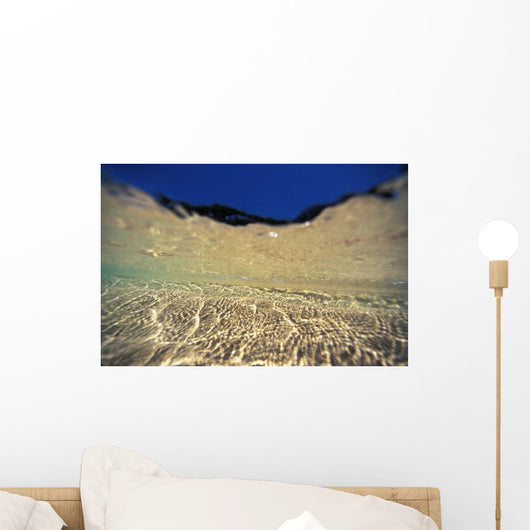 Underwater Reflections Along Sandy Bottom, At Surface Blue Sky Visible Wall Mural