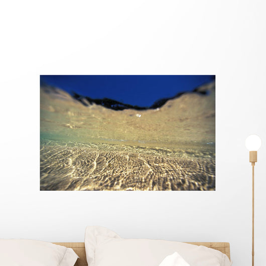Underwater Reflections Along Sandy Bottom, At Surface Blue Sky Visible Wall Mural