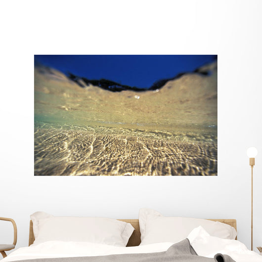 Underwater Reflections Along Sandy Bottom, At Surface Blue Sky Visible Wall Mural