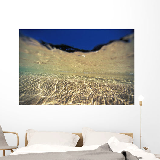 Underwater Reflections Along Sandy Bottom, At Surface Blue Sky Visible Wall Mural