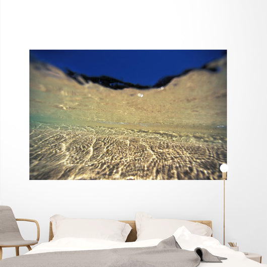 Underwater Reflections Along Sandy Bottom, At Surface Blue Sky Visible Wall Mural