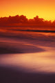 Beach At Sunset With Gentle Wave Rolling In Wall Mural