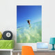 Over/Under View Of Woman Holding Surfboard On Head Wall Mural