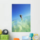Over/Under View Of Woman Holding Surfboard On Head Wall Mural