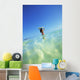 Over/Under View Of Woman Holding Surfboard On Head Wall Mural