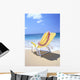 Back View Of Yellow Beach Chair In Sand Wall Mural