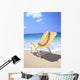 Back View Of Yellow Beach Chair In Sand Wall Mural