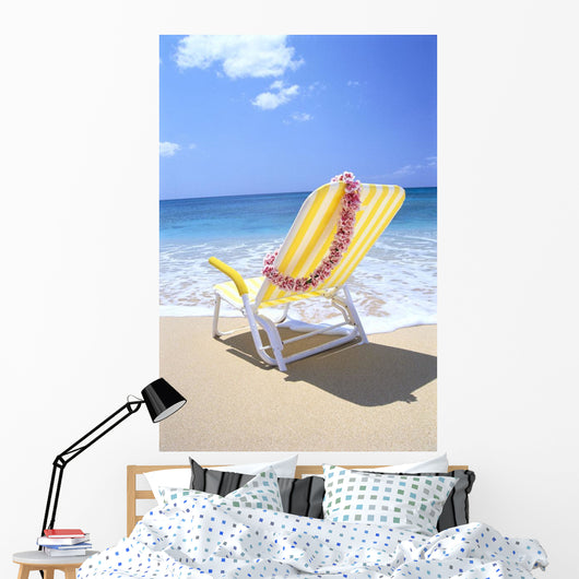 Back View Of Yellow Beach Chair In Sand Wall Mural
