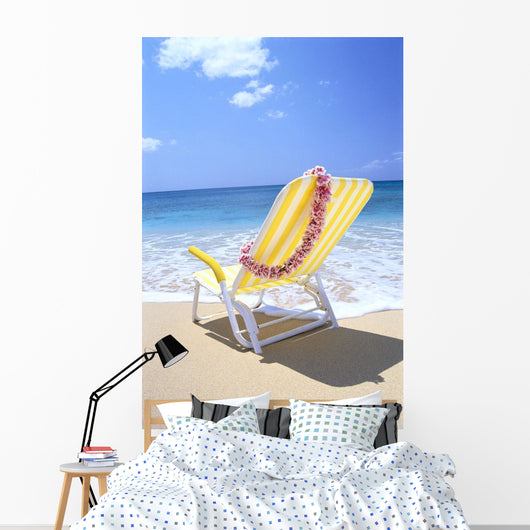 Back View Of Yellow Beach Chair In Sand Wall Mural