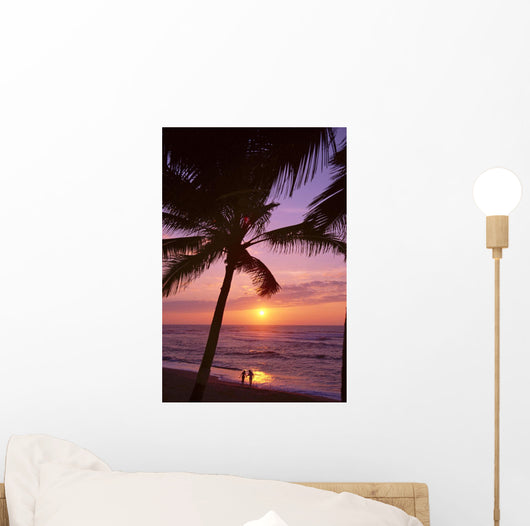 Couple In Distance On Beach Shoreline At Sunset Wall Mural