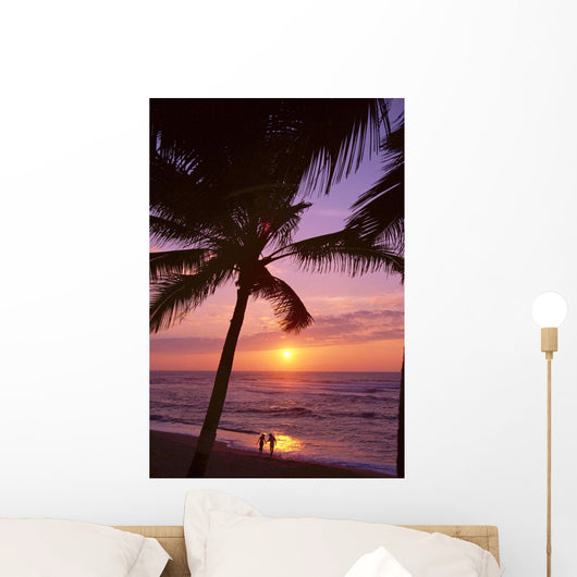 Couple In Distance On Beach Shoreline At Sunset Wall Mural