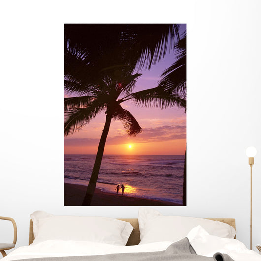 Couple In Distance On Beach Shoreline At Sunset Wall Mural