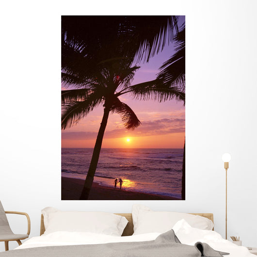 Couple In Distance On Beach Shoreline At Sunset Wall Mural