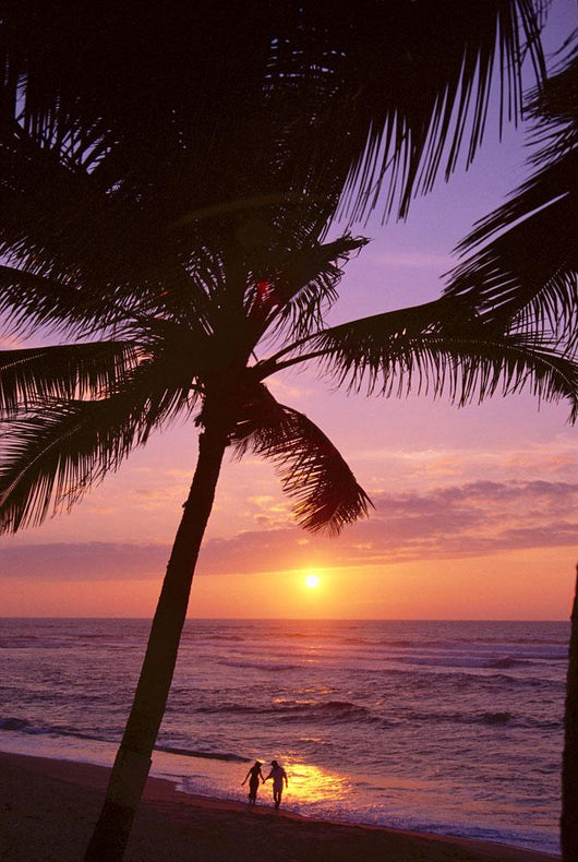 Couple In Distance On Beach Shoreline At Sunset Wall Mural