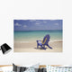 Plumeria Lei Hanging Over Blue Beach Chair Along Shoreline Wall Mural