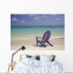 Plumeria Lei Hanging Over Blue Beach Chair Along Shoreline Wall Mural