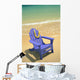 Blue Chair Along Shoreline With Plumeria Lei Hanging On Side Wall Mural