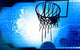 A basketball is coming down through net Wall Mural