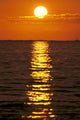 Sunset Reflections On Dark Ocean Water, Sun Ball In Orange Sky Wall Mural