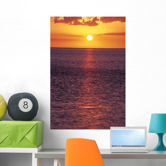 Sunset With Orange Sky Over Ocean Purple Surface With Reflections Wall Mural