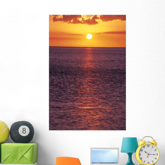 Sunset With Orange Sky Over Ocean Purple Surface With Reflections Wall Mural