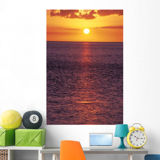 Sunset With Orange Sky Over Ocean Purple Surface With Reflections Wall Mural